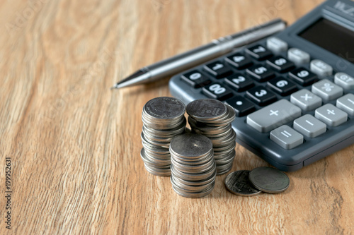 Financial  concept, Pen and calculator with coins  graph paper on the table