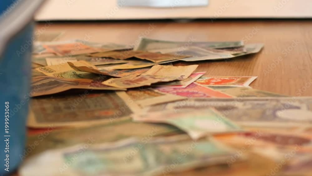 Sweep out pile of different paper money from a floor smotth dolly shot - nonsence concept Sweep out pile of different paper money from a floor smotth dolly shot - nonsence concept