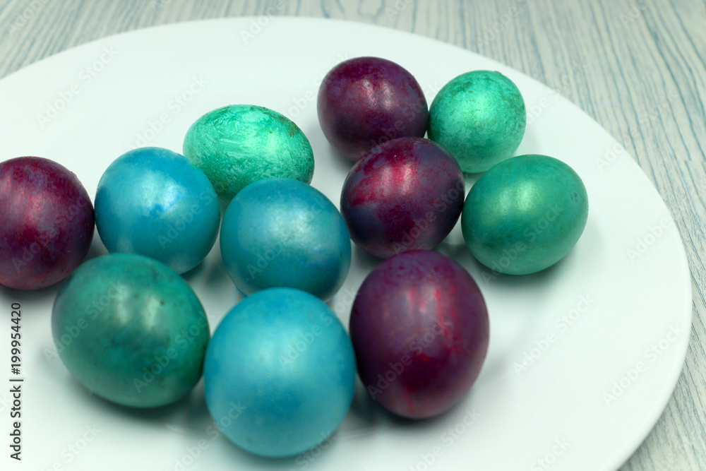 Easter eggs on a blue wooden table .
