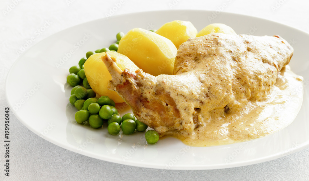 rabbit in mustard sauce garnished with potato and peas rabbit in mustard sauce garnished with potato and peas