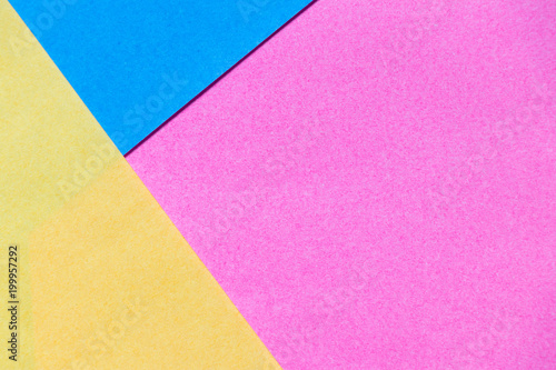Pink, yellow and blue color paper display as abstract blank background