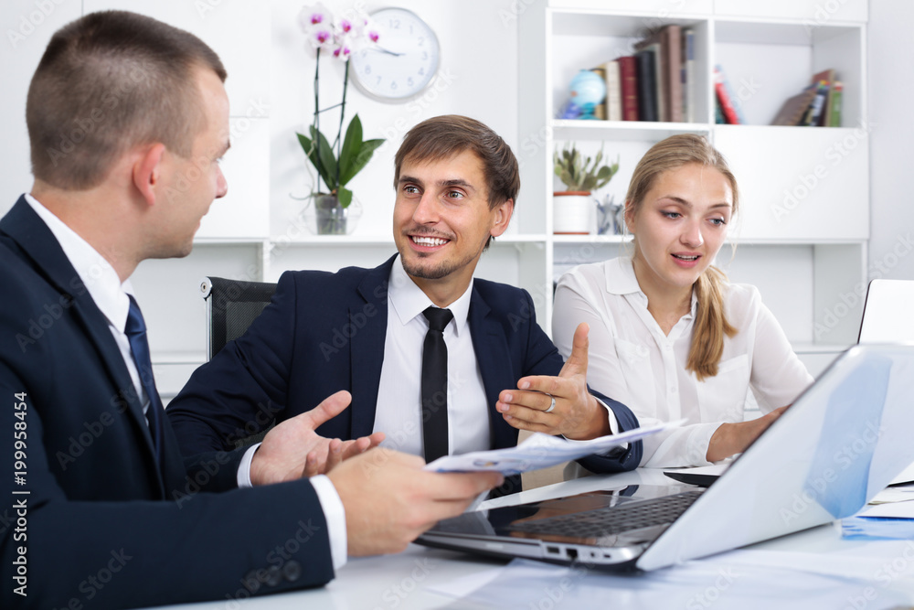 Fototapeta premium Three coworkers having a conversation