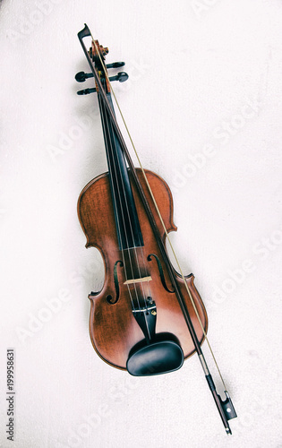 The abstract art design background of wooden violin and bow ,put on white background,in dramatic tone,show body of violin.