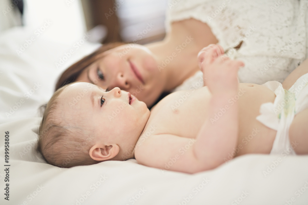 mother playing with her baby in the bedroom mother playing with her baby in the bedroom