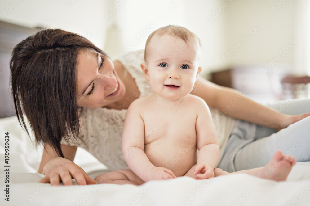 mother playing with her baby in the bedroom mother playing with her baby in the bedroom
