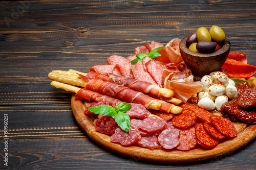 Meat and cheese plate with salami sausage, chorizo, parma and mozzarella