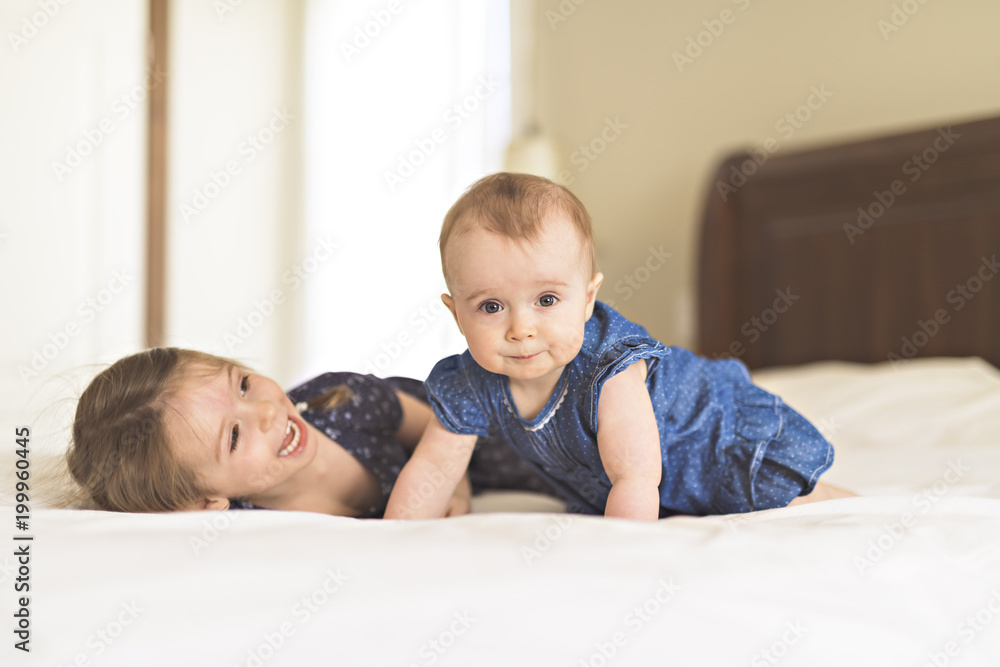 Portrait of brother and sister. Two cute children on bed Portrait of brother and sister. Two cute children on bed