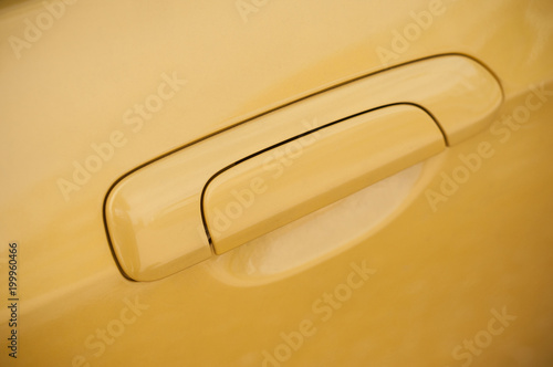 closeup of yellow handle on modern car