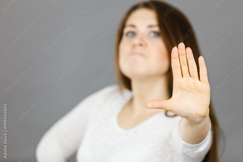 Angry apodicticity woman showing stop with hand Angry apodicticity woman showing stop with hand