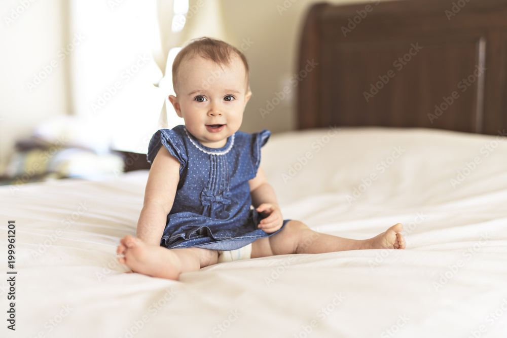 Portrait of a baby on the bed in her room Portrait of a baby on the bed in her room