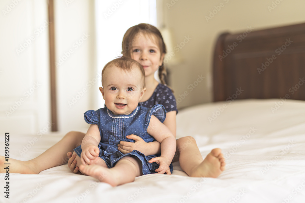 Portrait of brother and sister. Two cute children on bed Portrait of brother and sister. Two cute children on bed