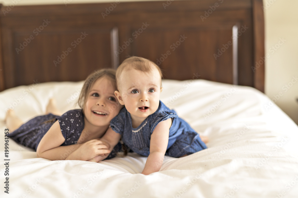Portrait of brother and sister. Two cute children on bed Portrait of brother and sister. Two cute children on bed
