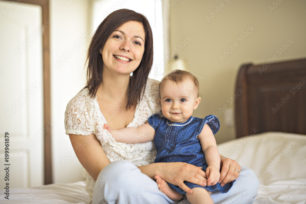 mother playing with her baby in the bedroom mother playing with her baby in the bedroom