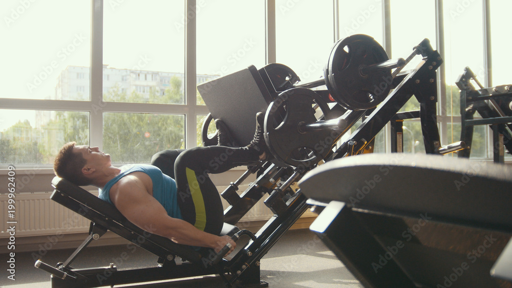 Strong man powerlifter on the strength training in a gym Strong man powerlifter on the strength training in a gym