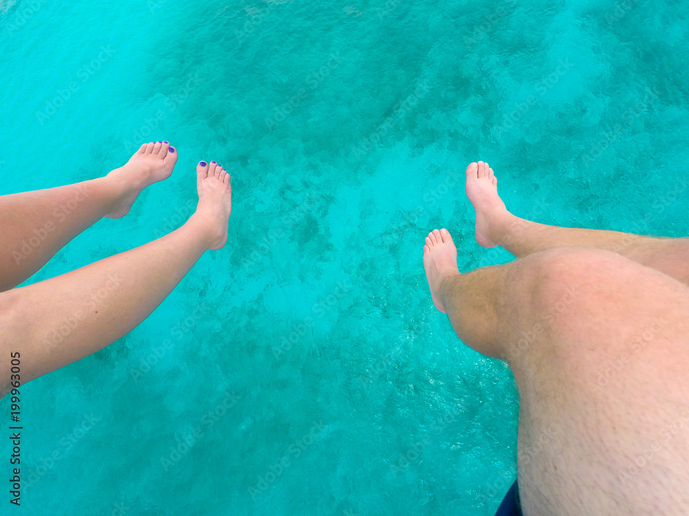 Feet dangling over water
