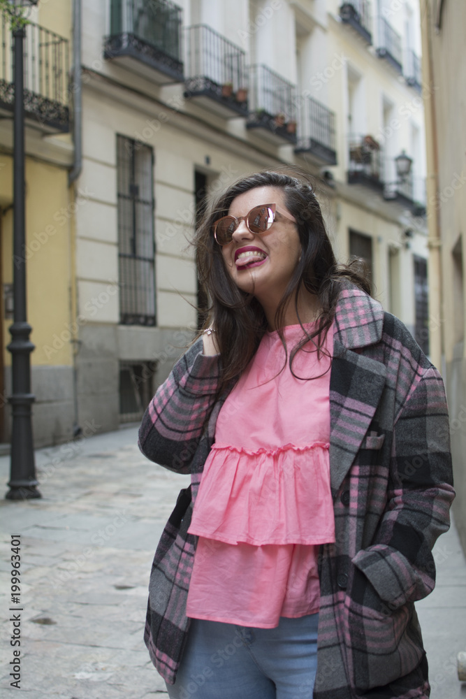 portrait of young woman in street with sunglasses