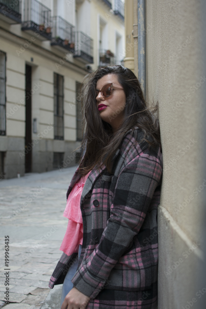 portrait of young woman in street with sunglasses portrait of young woman in street with sunglasses