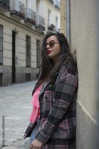 portrait of young woman in street with sunglasses