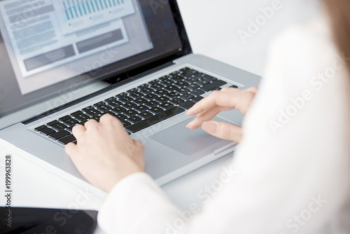 Close-up shot of businesswoman 's hand typing on keyboard. 