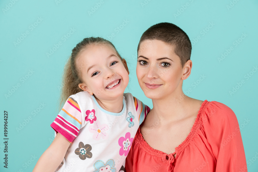 Cute preschool age girl with her mother, young cancer patient in remission. Cancer patient and family support concept. Cute preschool age girl with her mother, young cancer patient in remission. Cancer patient and family support concept.