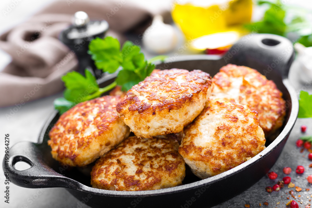 Cutlets. Fried cutlets in cast-iron pan on table Cutlets. Fried cutlets in cast-iron pan on table