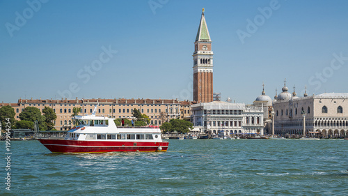 Red boat near St. Mark's Square on the Grand Canal in Venice, Italy.