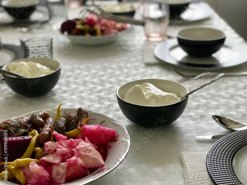 Turkish Food Yogurt with Pickle at Dinner Table.