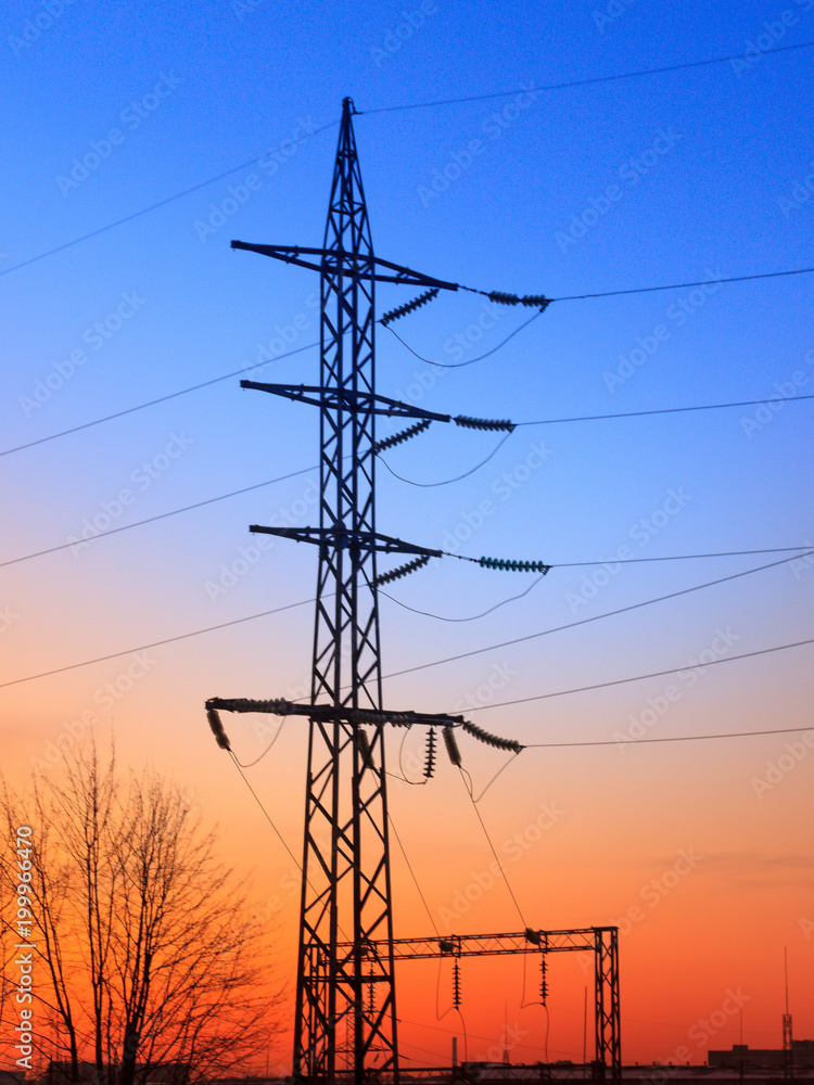 Fototapeta premium High voltage electricity pylons and transmission power lines on the blue sky background.
