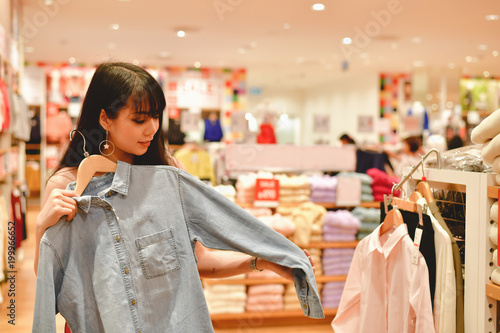 Shopping Concept. Asian girls are shopping in the mall. Beautiful women are happy to shop in the mall. Beautiful girl walking in the mall.