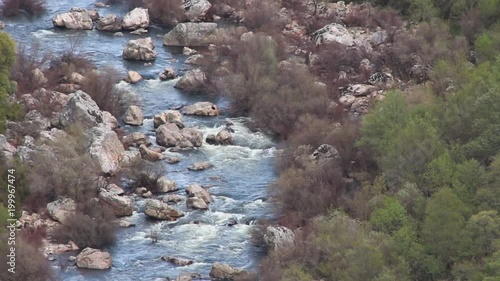 Aerial fixed shot of river, creek stream. Nature green background photo