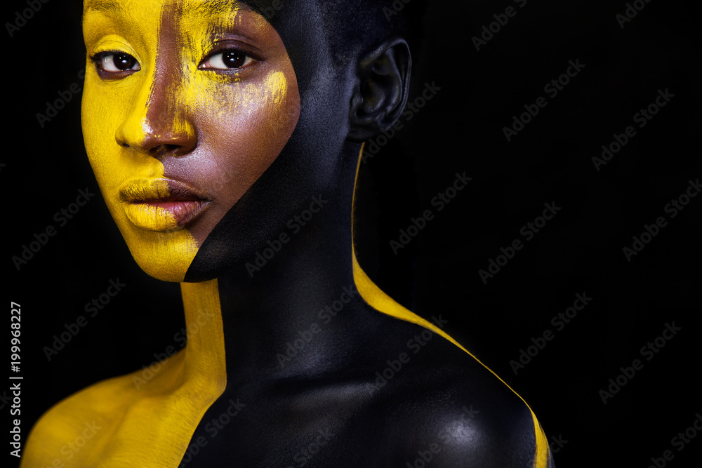 © Mike Orlov - Black and yellow makeup. Cheerful young african woman with art fashion makeup. © Mike Orlov - Black and yellow makeup. Cheerful young african woman with art fashion makeup.