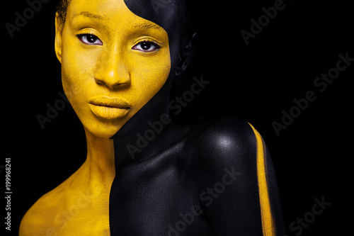Black and yellow makeup. Cheerful young african woman with art fashion makeup.