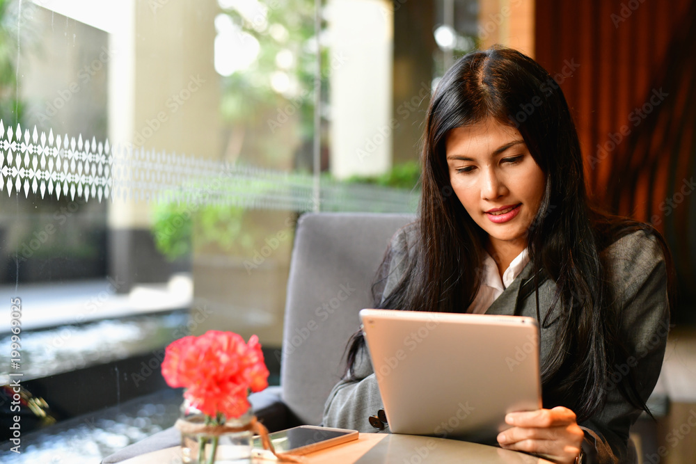 Business Concept.Young Asian businesswoman is working happily.Young businesswoman working in a cafe.Young businesswoman is relaxation in a coffee shop. Business Concept.Young Asian businesswoman is working happily.Young businesswoman working in a cafe.Young businesswoman is relaxation in a coffee shop.