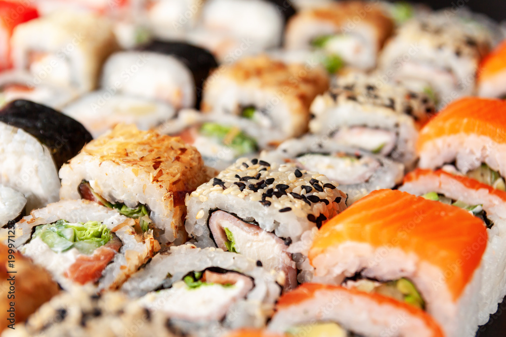 Assorted sushi rolls on black background Assorted sushi rolls on black background