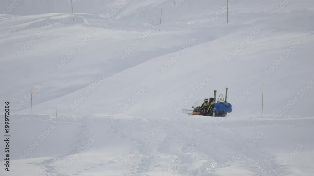 Two people riding on a snowmobile Two people riding on a snowmobile