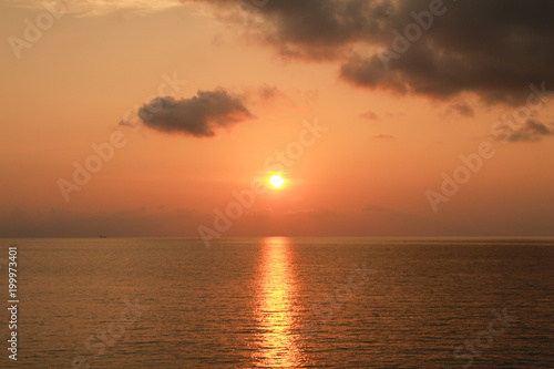 Fototapeta Naklejka Na Ścianę i Meble -  sunset at the sea orange sky beautiful clouds