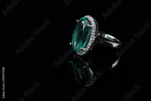 Silver ring with a green amethyst on a black background