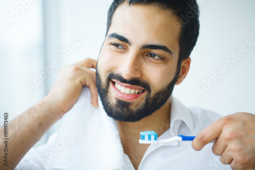 Man With Beautiful Smile  Healthy White Teeth With Toothbrush. High Resolution Image