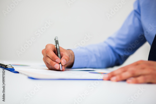 Closeup of a businessman writing documents