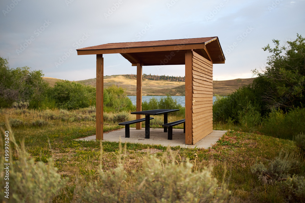 Wooden covered picnic hut with table and chairs Wooden covered picnic hut with table and chairs