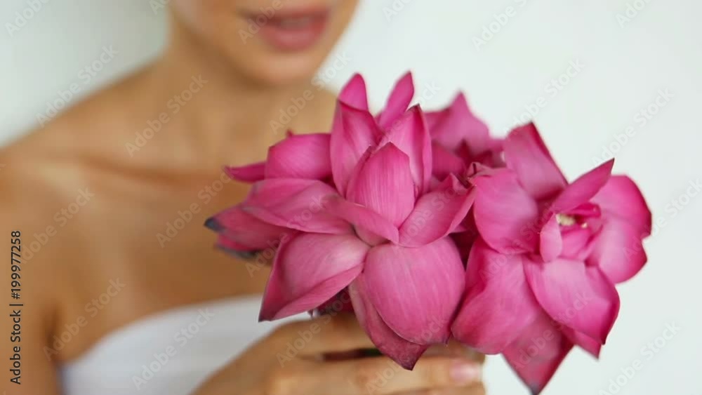 Woman holding a pink Lotus close-up. Beautiful girl with big exotic flower bouquet. Lotus (Nelumbo nucifera) is considered a Sacred Buddha flower. Wellness, Spa and Relaxation Outdoors in Asia Woman holding a pink Lotus close-up. Beautiful girl with big exotic flower bouquet. Lotus (Nelumbo nucifera) is considered a Sacred Buddha flower. Wellness, Spa and Relaxation Outdoors in Asia