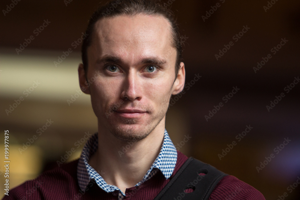 a serious guy in a red sweater. portrait. a serious guy in a red sweater. portrait.
