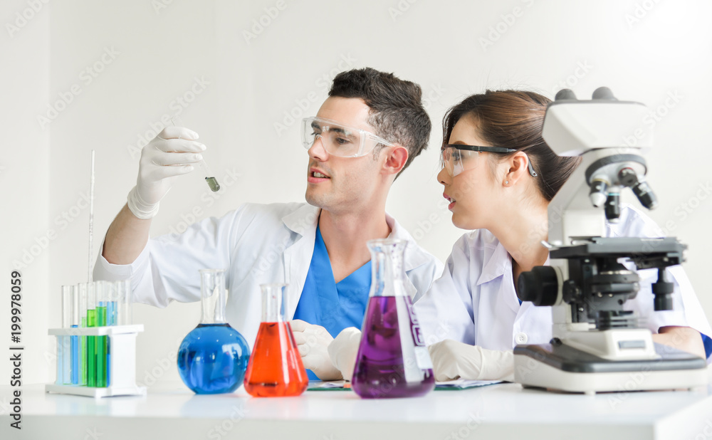 Two scientists are working in laboratory. Two scientists are working in laboratory.