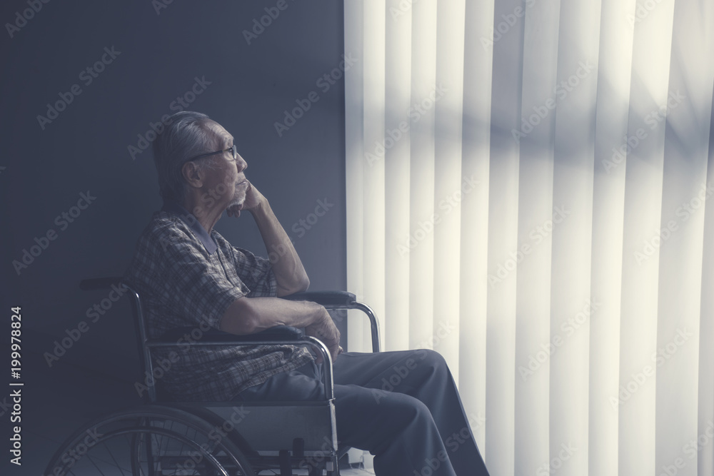 Sad lonely senior man sitting on wheelchair Sad lonely senior man sitting on wheelchair