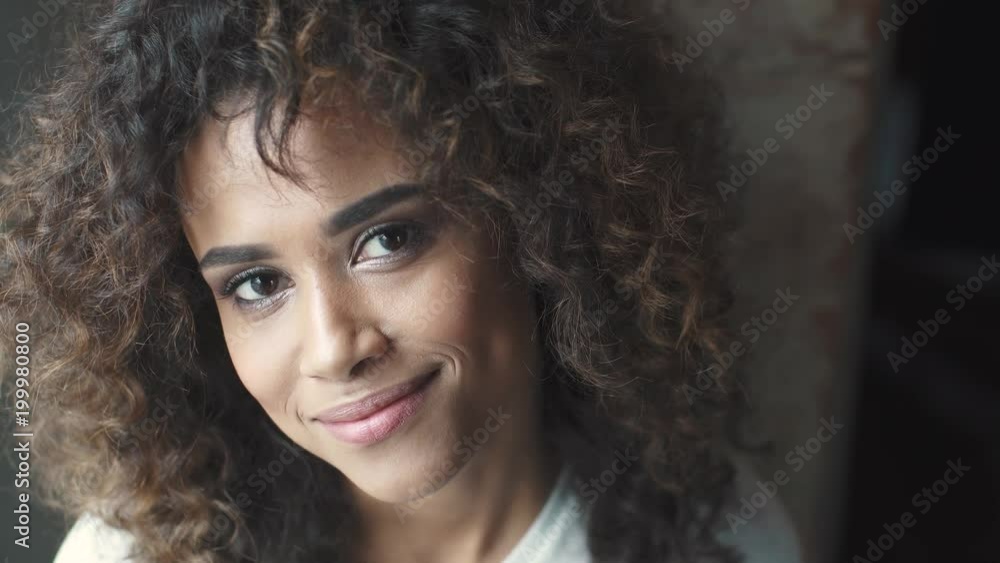 headshot portrait of a attractive hispanic girl with a beautiful smile. woman smiles and looks into the camera headshot portrait of a attractive hispanic girl with a beautiful smile. woman smiles and looks into the camera