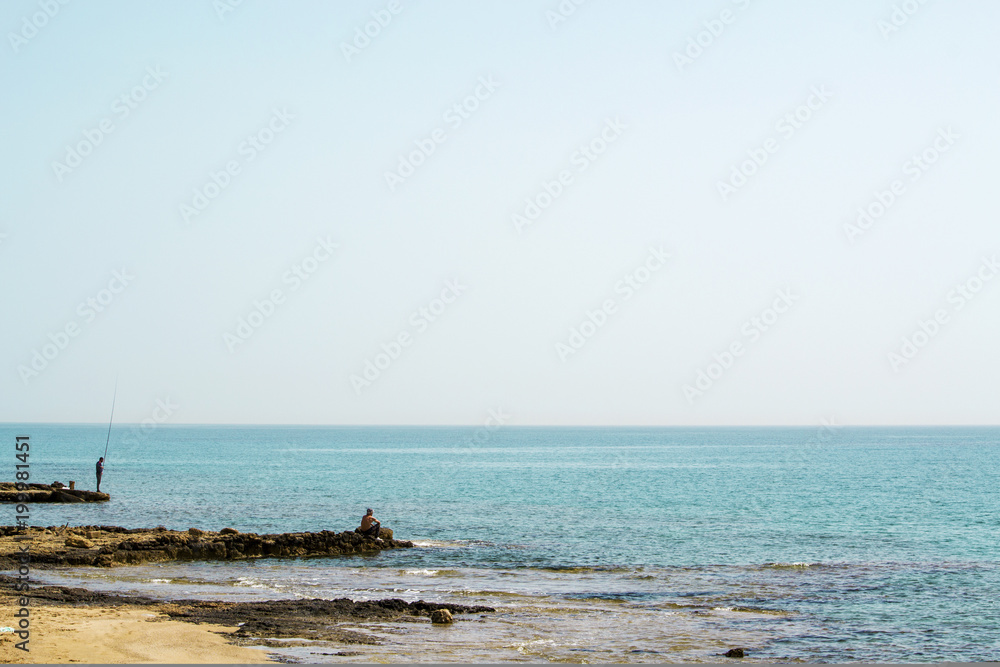 Two fishermans on the shore