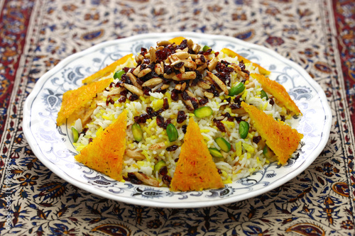 zereshk polo with tahdig, saffron barberry rice with scorched rice, iranian persian cuisine photo