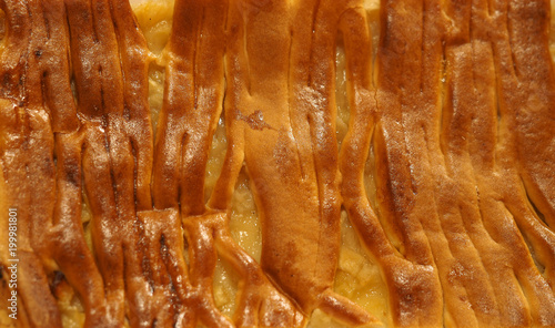 Apple pie background. Textured surface of freshly baked apple pie, close-up