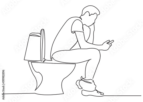 the man is sitting on the toilet with the phone