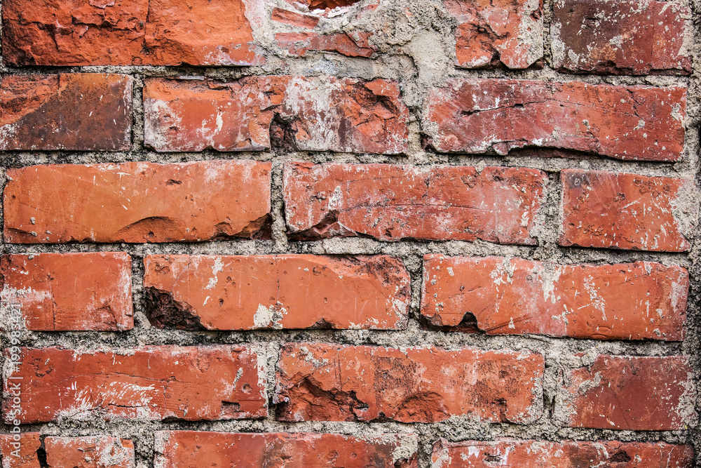 Cracked red brick wall, blocks in a line background Cracked red brick wall, blocks in a line background